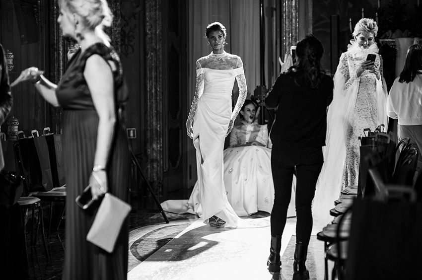 model wearing a wedding dress backstage from the fashion show